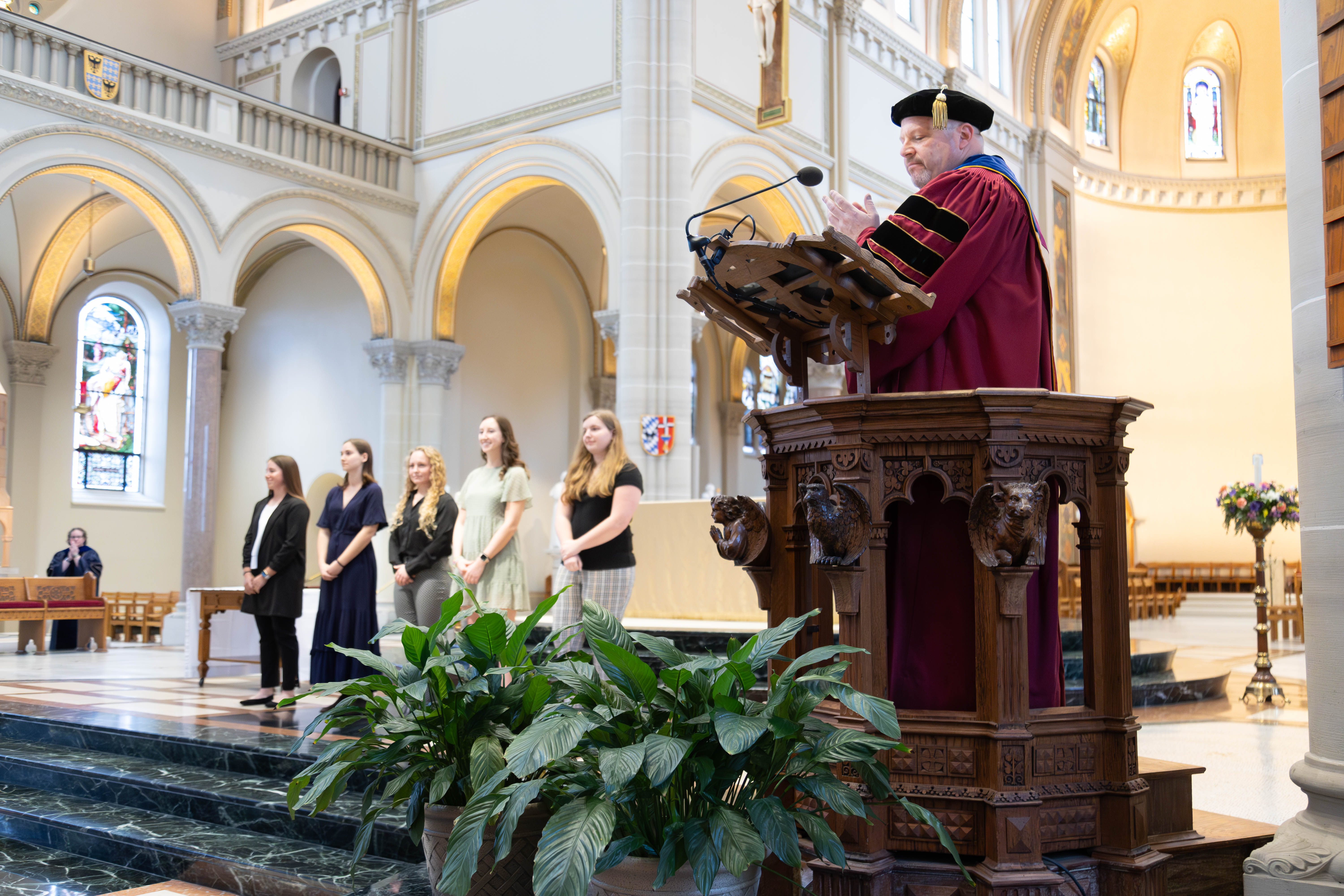 Fr. Paul Taylor, O.S.B., president of Saint Vincent College, applauds the finalists for the 50th annual President’s Award during the 2024 Honors Convocation.