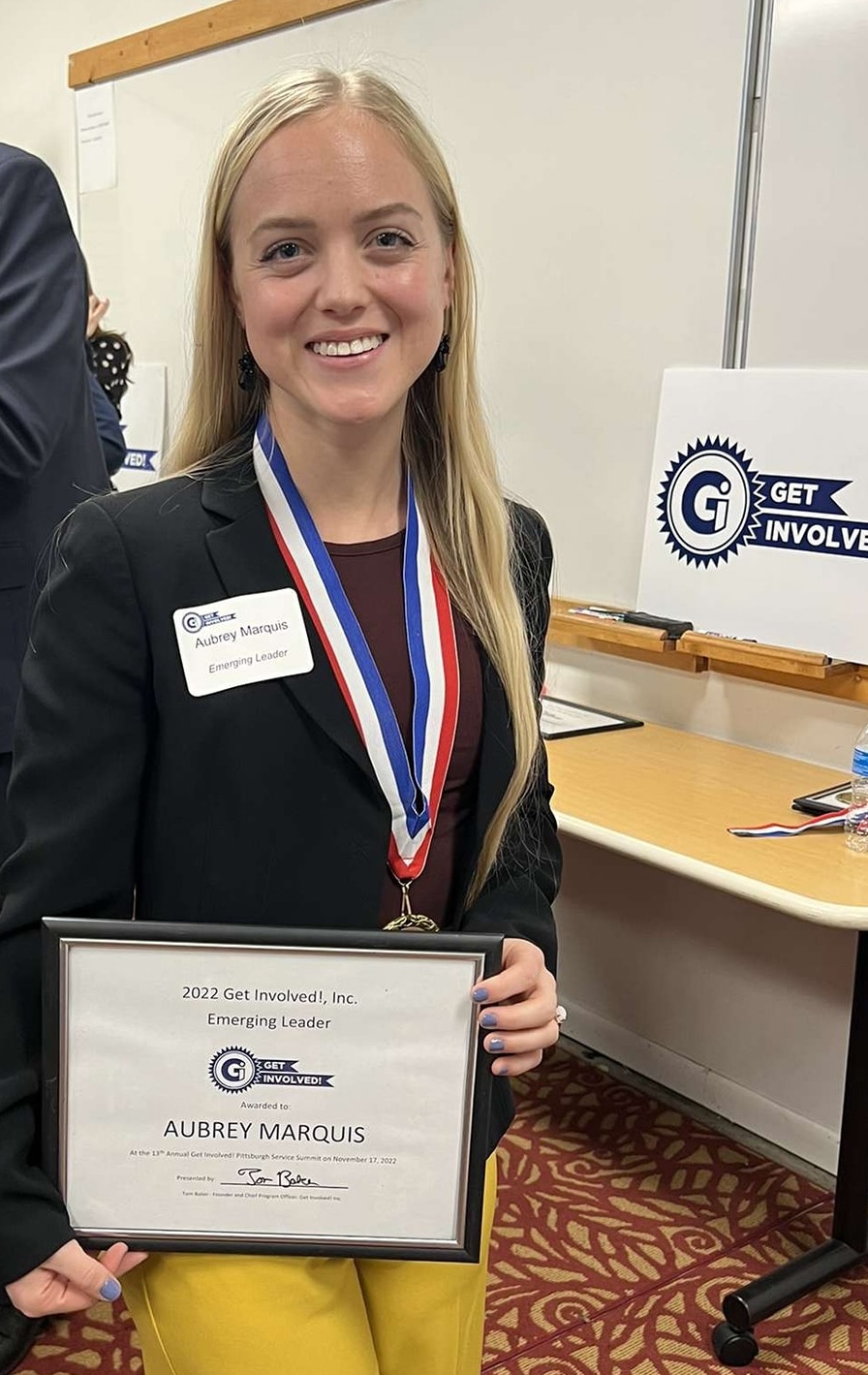 Aubrey Marquis with her 2022 Emerging Leader Award from Get Involved!, Inc.