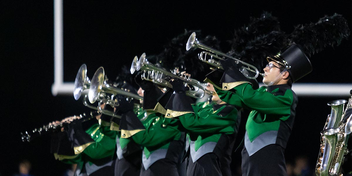 student playing instruments in a band