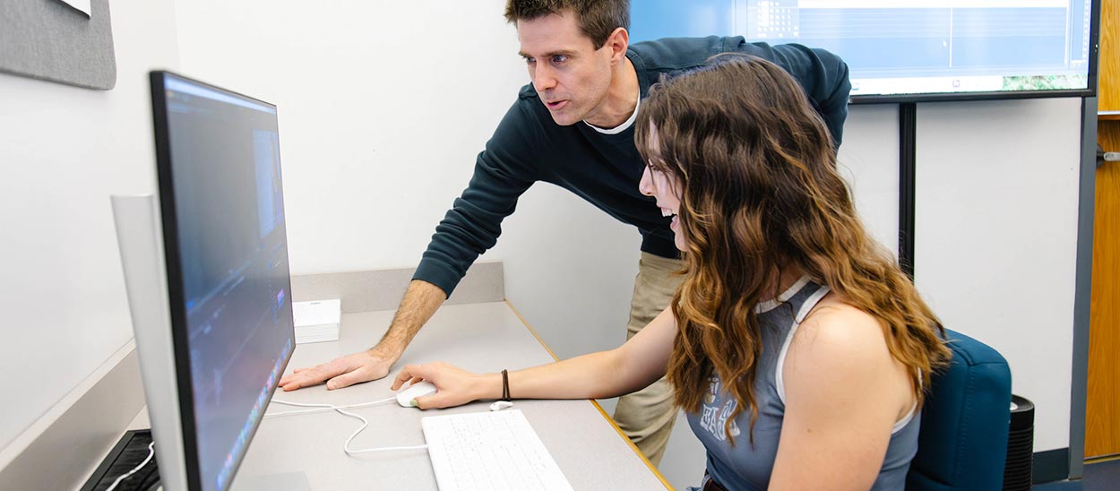 Associate Professor David Safin assisting a student on a project in the computer lab Associate Professor David Safin assisting a student on a project in the computer lab