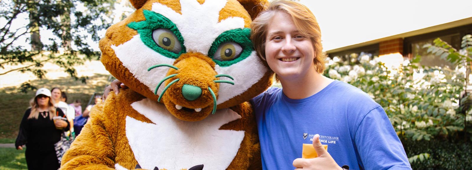 photo of mascot vinnie the bearcat and student at saint vincent