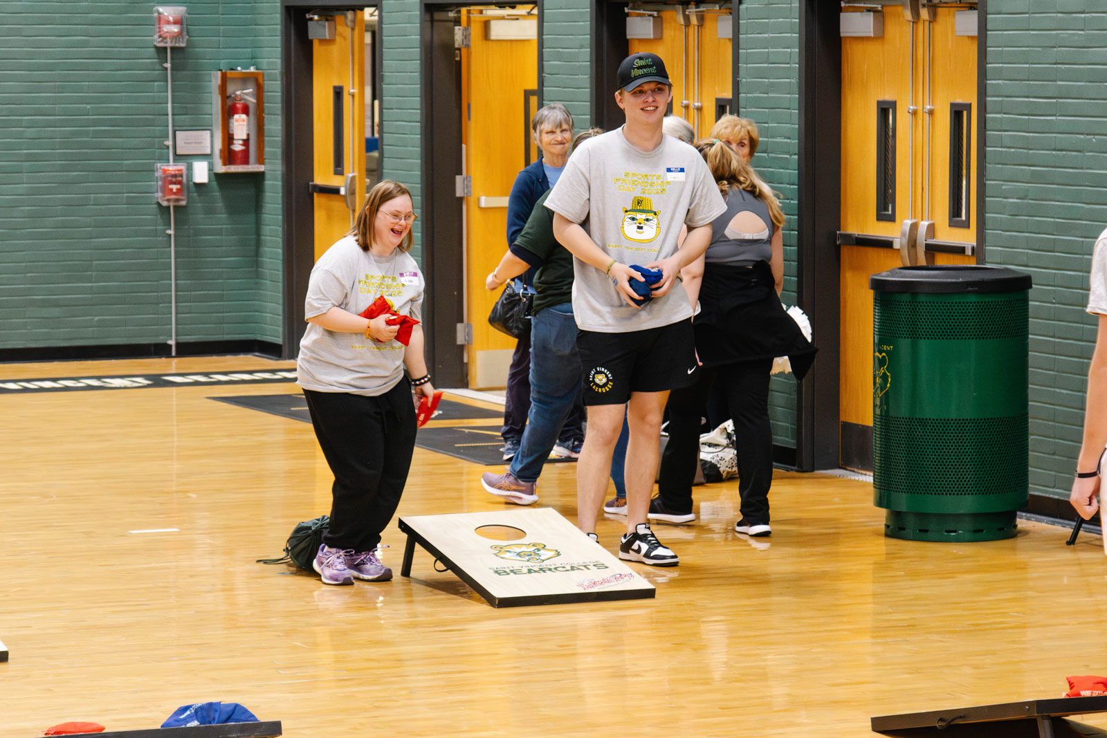 Participants enjoying a game of cornhole during an inclusive sports event.